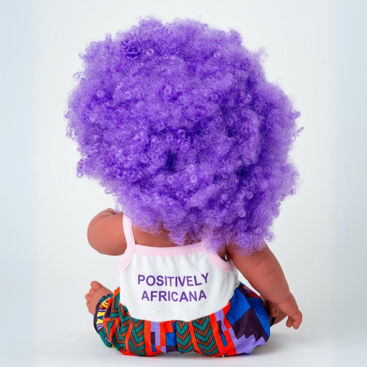 The Aimee Doll in Purple Afro Hair and Branded Jumpsuit - Light Brown